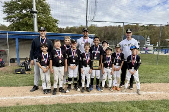 A young Warpath team with medals and a plaque