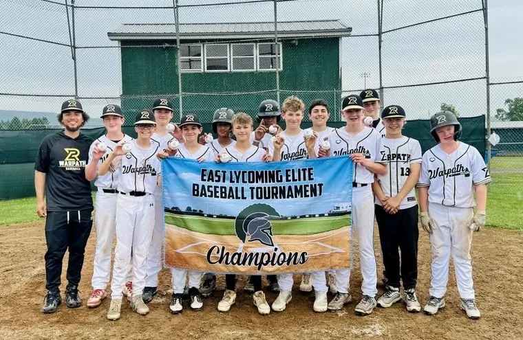 A Warpath team holding a tournament champions banner
