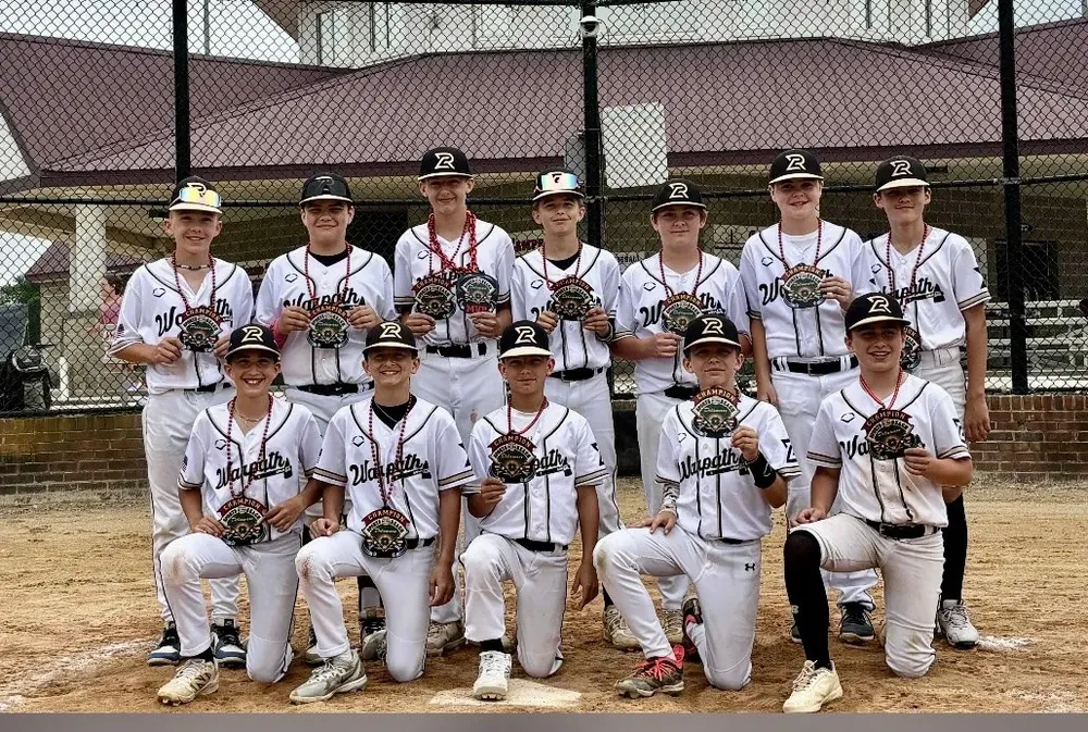 A Warpath team photo in front of a dugout