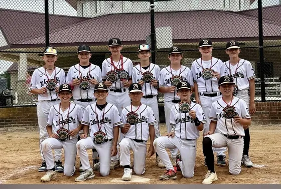 A Warpath team photo in front of a dugout
