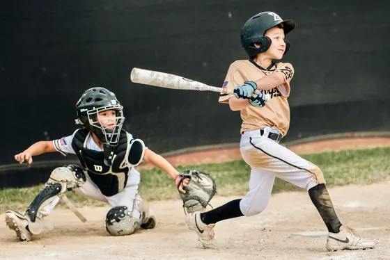 A young Warpath hitter swinging at a pitch
