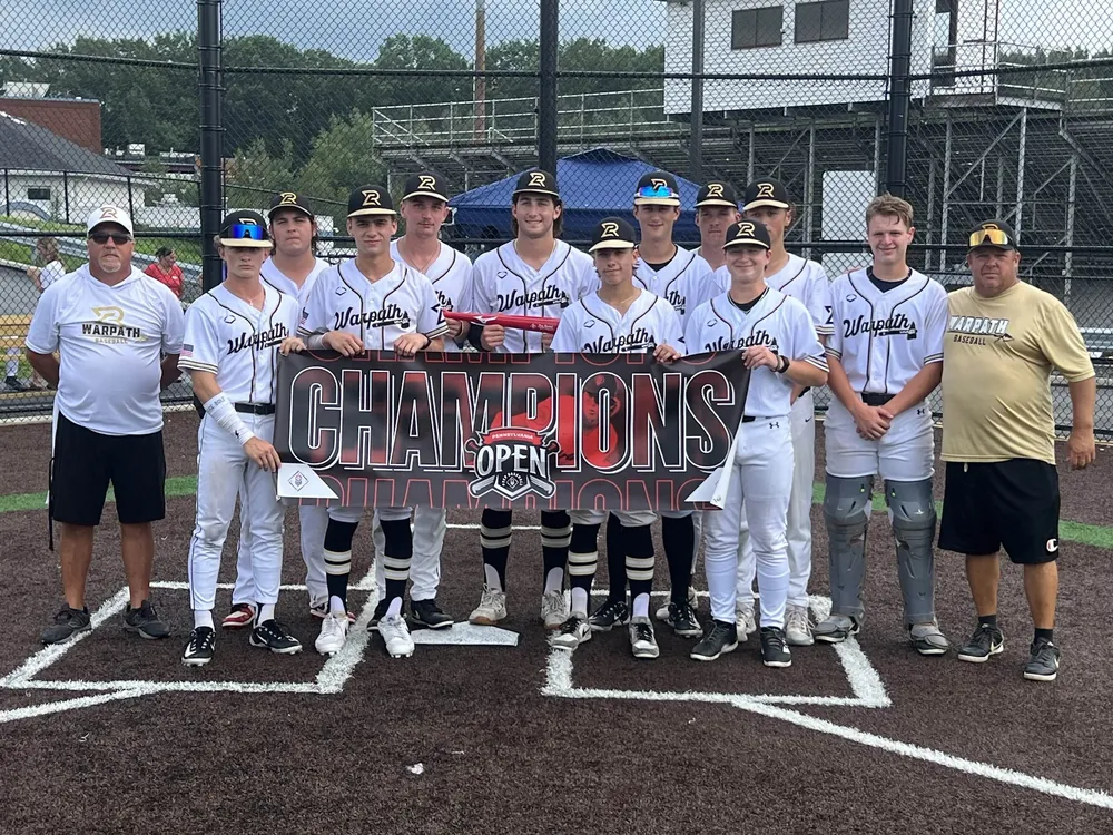 A Warpath team with a champions banner at home plate