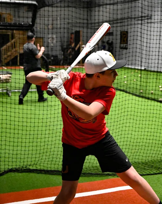 A young hitter in the batting cage at RCS Academy