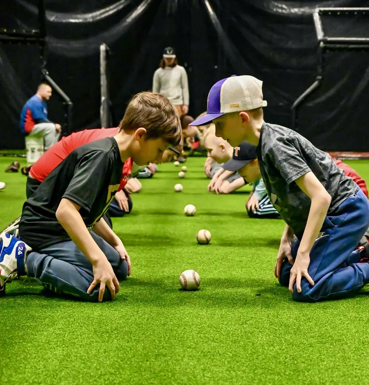 Two young athletes doing a reaction drill on the turf