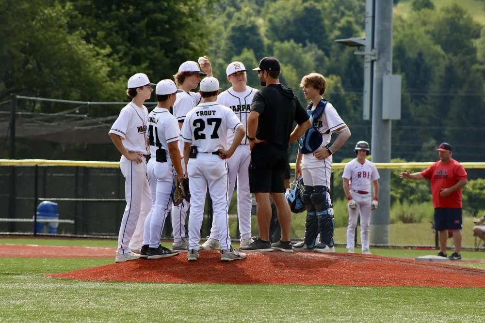 Russ Canzler talking with his players on the mound